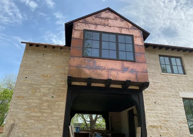 Copper metal panel facade on a stone building for Metal Roof Coating in Wauwatosa